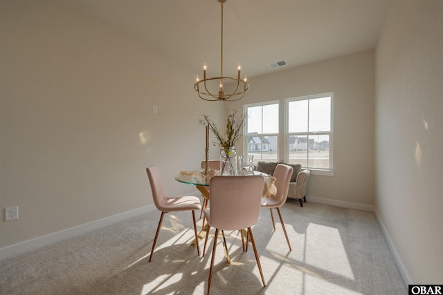 carpeted dining area featuring visible vents, a notable chandelier, and baseboards