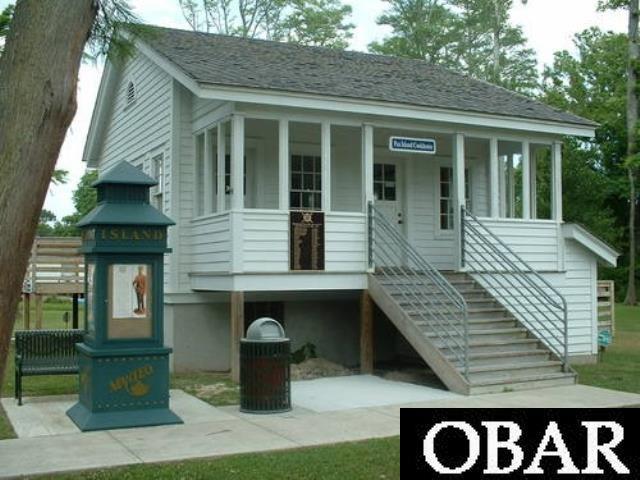 view of front of house with a shingled roof and stairway