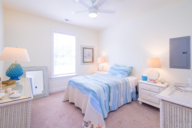 bedroom featuring ceiling fan, light colored carpet, visible vents, baseboards, and electric panel