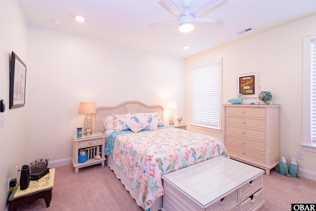 bedroom featuring baseboards, visible vents, a ceiling fan, and light colored carpet