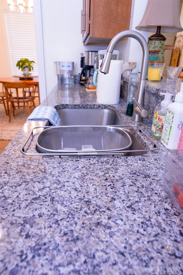 details featuring a sink and brown cabinets