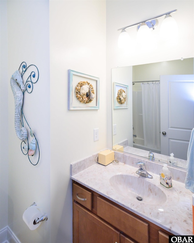 bathroom featuring shower / bath combo and vanity