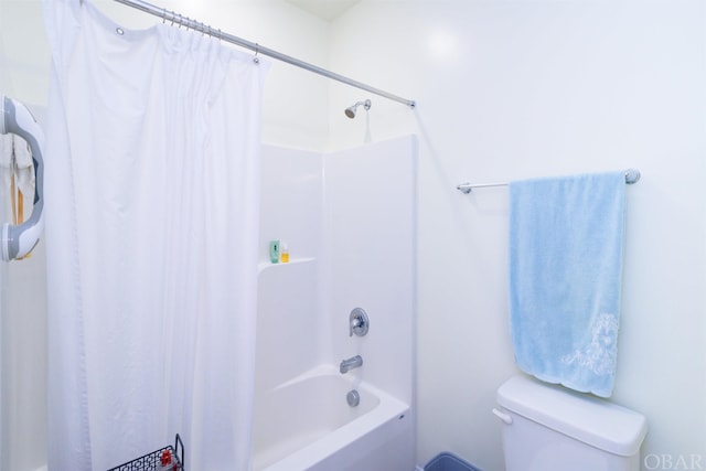 bathroom featuring shower / bath combination with curtain and toilet