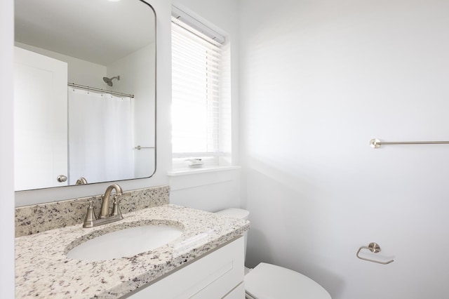508 Albatross Ln Lot 116, Corolla, NC 27927 - bathroom featuring curtained shower, vanity, toilet, and a wealth of natural light