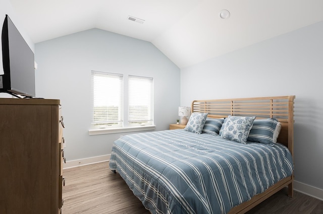 508 Albatross Ln Lot 116, Corolla, NC 27927 - bedroom with lofted ceiling, baseboards, visible vents, and wood finished floors