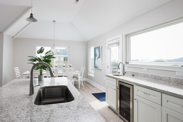 508 Albatross Ln Lot 116, Corolla, NC 27927 - kitchen featuring decorative light fixtures, beverage cooler, light wood-style flooring, and a sink