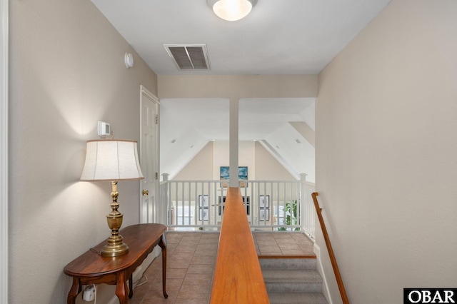 stairway featuring tile patterned floors and visible vents