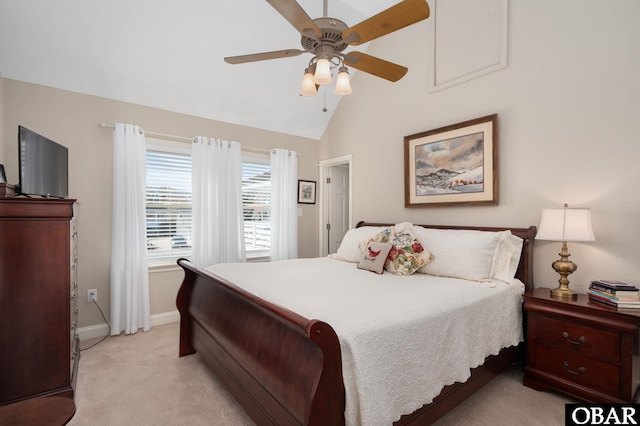 bedroom with vaulted ceiling, light colored carpet, baseboards, and ceiling fan