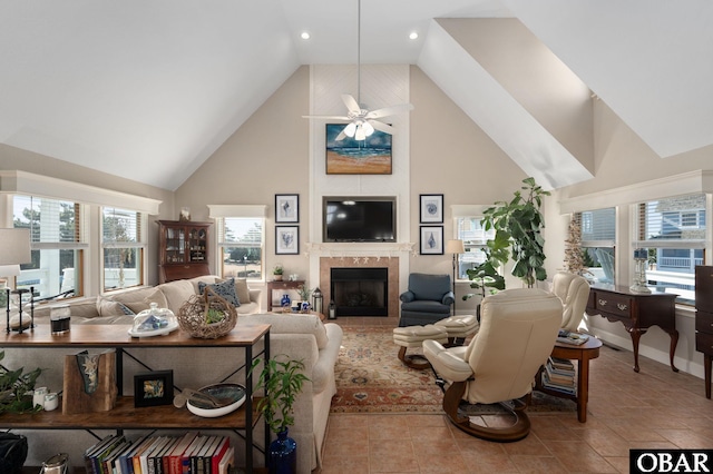 living room featuring a ceiling fan, plenty of natural light, a fireplace, and high vaulted ceiling