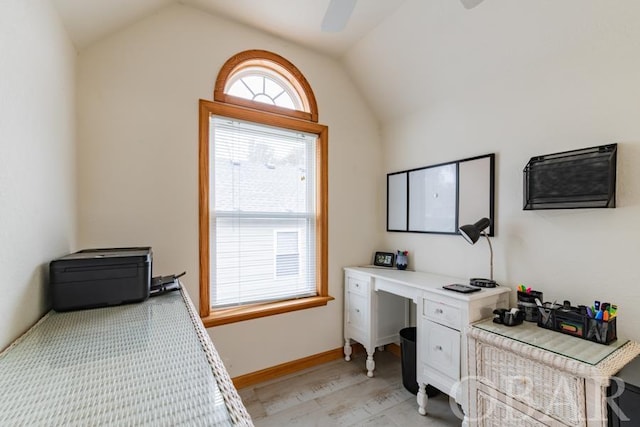 office featuring light wood-style floors, ceiling fan, baseboards, and vaulted ceiling