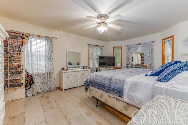 bedroom with light wood-type flooring and a ceiling fan