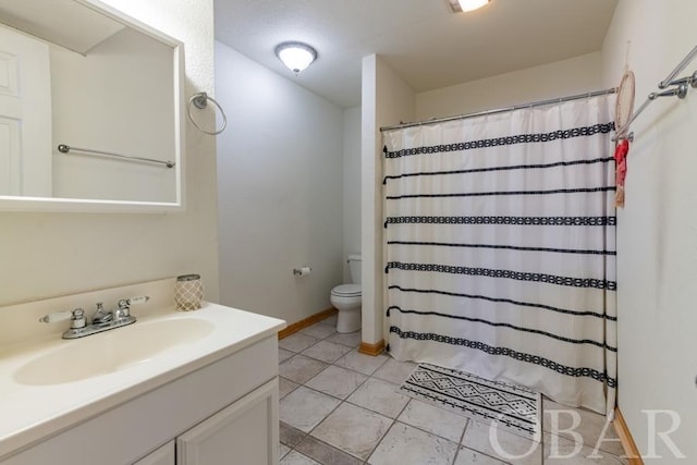 full bath featuring baseboards, vanity, toilet, and tile patterned floors