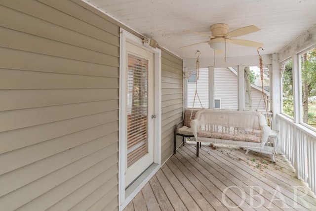 wooden terrace with a porch and a ceiling fan