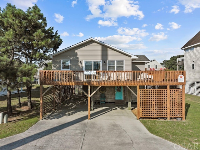 view of front of property with driveway and a wooden deck