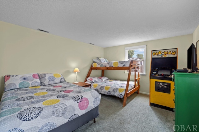 carpeted bedroom featuring visible vents and a textured ceiling