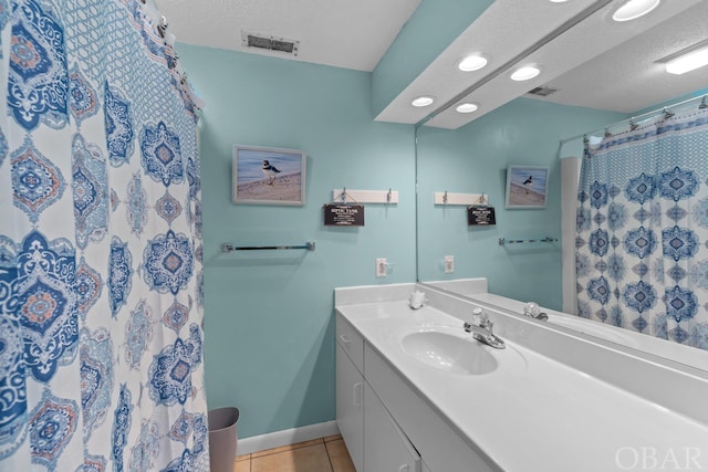 bathroom featuring visible vents, a textured ceiling, vanity, and tile patterned floors