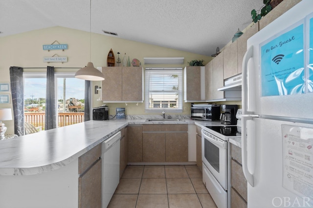 kitchen featuring a peninsula, white appliances, light countertops, and lofted ceiling