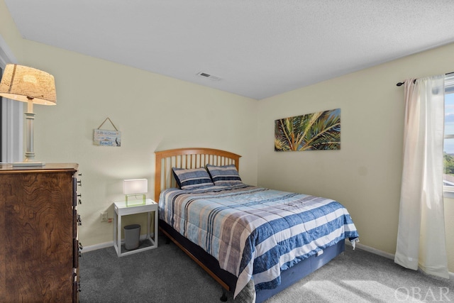 carpeted bedroom with visible vents and baseboards