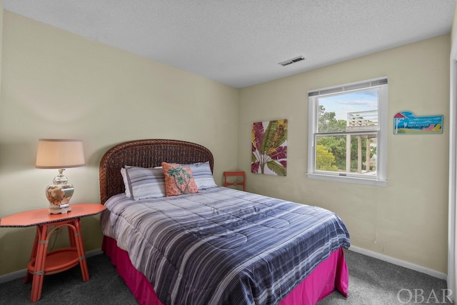 carpeted bedroom featuring baseboards, visible vents, and a textured ceiling