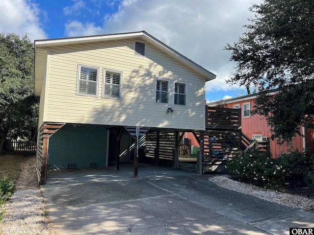 view of front facade featuring stairway, a carport, and concrete driveway