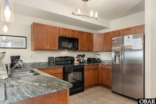 107 W Gray Eagle St Unit 213, Nags Head, NC 27959 - kitchen featuring black appliances, a sink, brown cabinetry, and light tile patterned floors