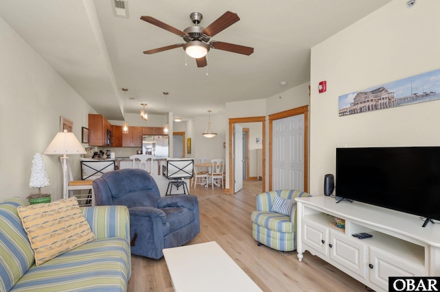 107 W Gray Eagle St Unit 213, Nags Head, NC 27959 - living room featuring ceiling fan and light wood finished floors