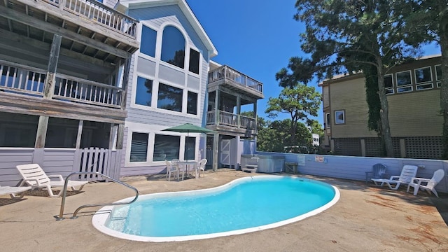 view of pool featuring a fenced in pool, a patio area, and a hot tub