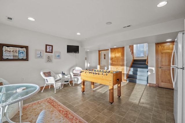 recreation room featuring baseboards, dark tile patterned floors, visible vents, and recessed lighting