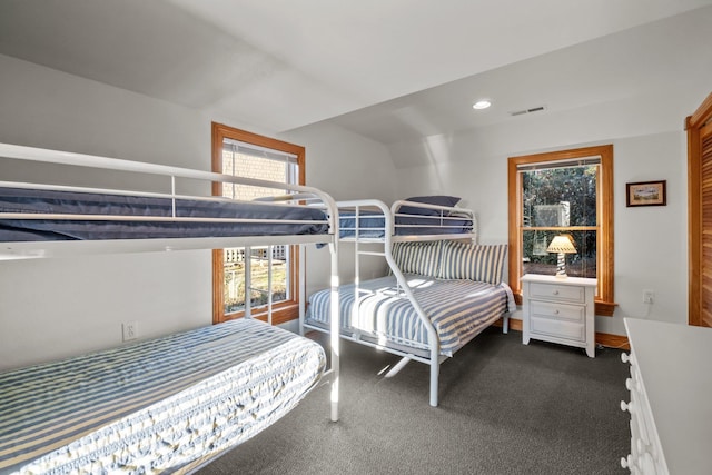 bedroom with multiple windows, visible vents, dark carpet, and recessed lighting