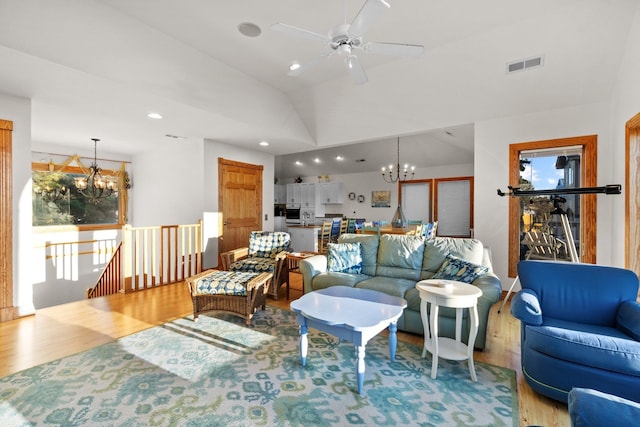 living room with lofted ceiling, visible vents, recessed lighting, and wood finished floors