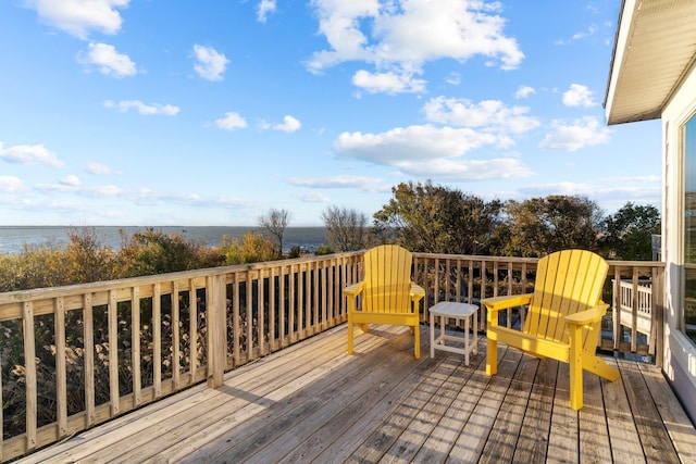 wooden terrace featuring a water view