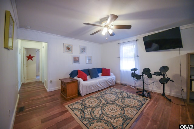 living room featuring baseboards, visible vents, wood finished floors, and a ceiling fan