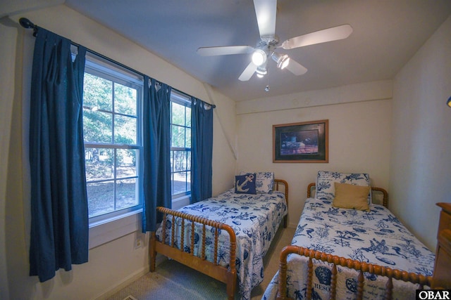 carpeted bedroom with baseboards and ceiling fan