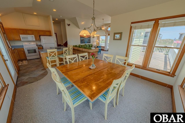 dining area featuring lofted ceiling, baseboards, and recessed lighting