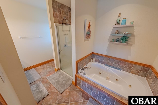 bathroom with a whirlpool tub, a stall shower, baseboards, and tile patterned floors