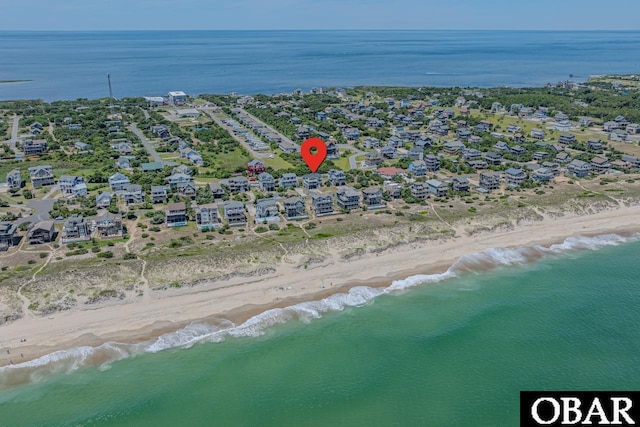 drone / aerial view with a water view and a view of the beach