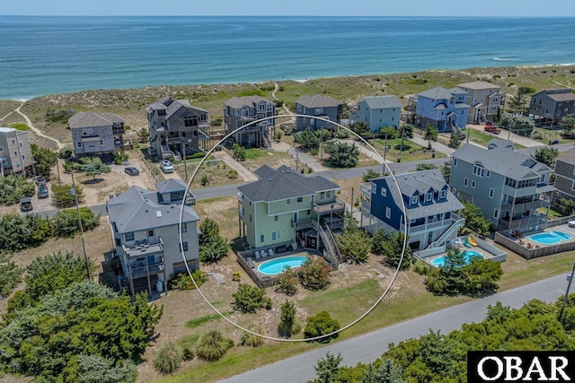 drone / aerial view featuring a water view and a residential view