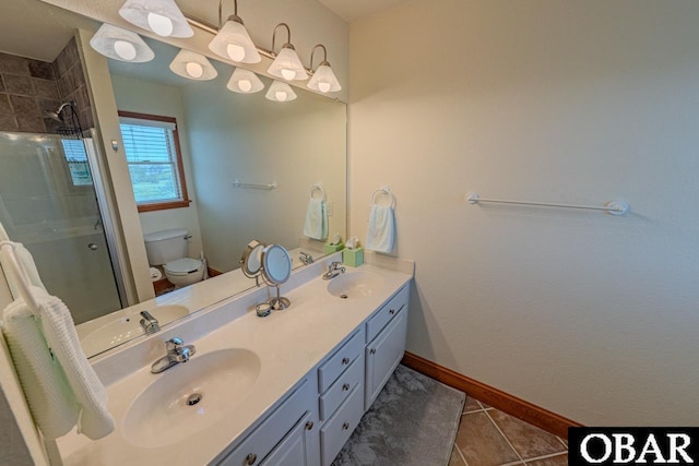 bathroom with a shower with shower door, a sink, and toilet