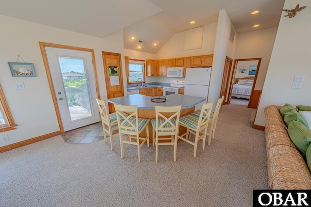 dining area with high vaulted ceiling, recessed lighting, baseboards, and light colored carpet