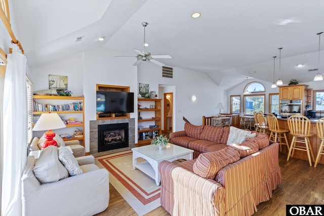 770 Bayberry Ct Lot 81, Corolla, NC 27927 - living area featuring light wood-style flooring, a tiled fireplace, a ceiling fan, high vaulted ceiling, and recessed lighting