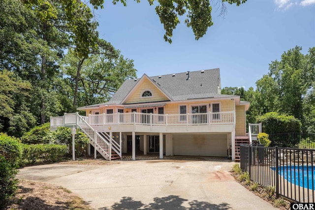 4 Birch Ln Lot 15, Southern Shores, NC 27949 - beach home with stairway, a shingled roof, an attached garage, concrete driveway, and a wooden deck