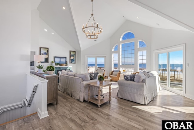 54053 Sandpiper Dr Lot 4, Frisco, NC 27936 - living room with a chandelier, high vaulted ceiling, wood finished floors, and healthy amount of natural light
