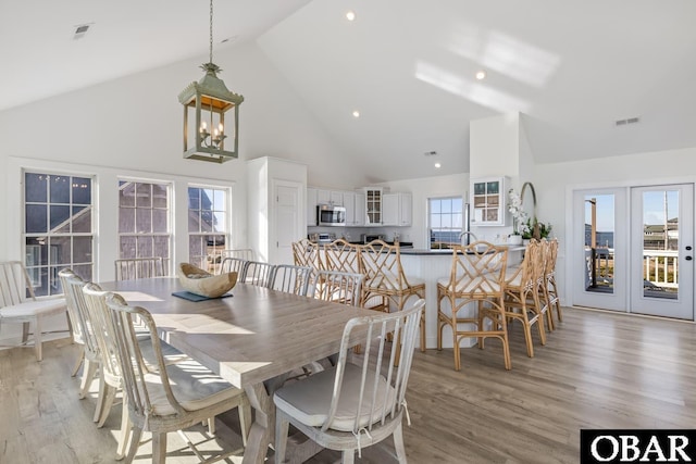 54053 Sandpiper Dr Lot 4, Frisco, NC 27936 - dining space featuring high vaulted ceiling, light wood finished floors, and a chandelier