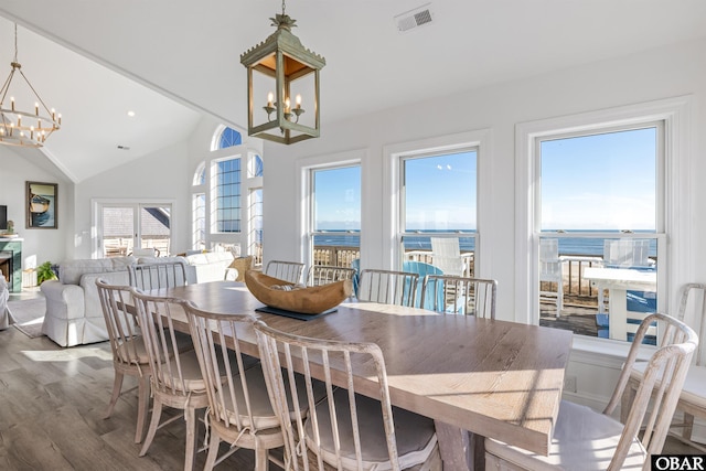 54053 Sandpiper Dr Lot 4, Frisco, NC 27936 - dining room with a chandelier, wood finished floors, vaulted ceiling, and a water view
