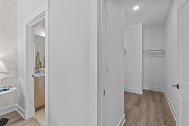 spacious closet with light wood finished floors