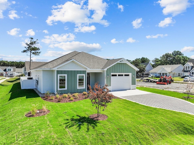 single story home with board and batten siding, fence, a garage, driveway, and a front lawn