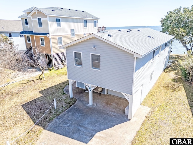 107 Rhodoms Dr Lot 1, Kill Devil Hills, NC 27948 - rear view of property featuring a carport and stairway