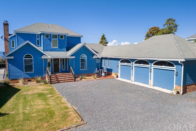 view of front of property featuring driveway, a shingled roof, an attached garage, and a front yard