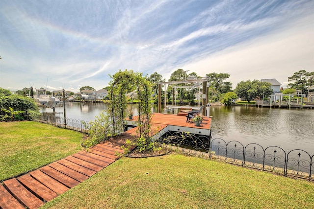 dock area featuring a lawn, a water view, and boat lift