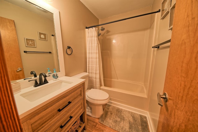 full bath with toilet, wood finished floors, shower / tub combo with curtain, and vanity